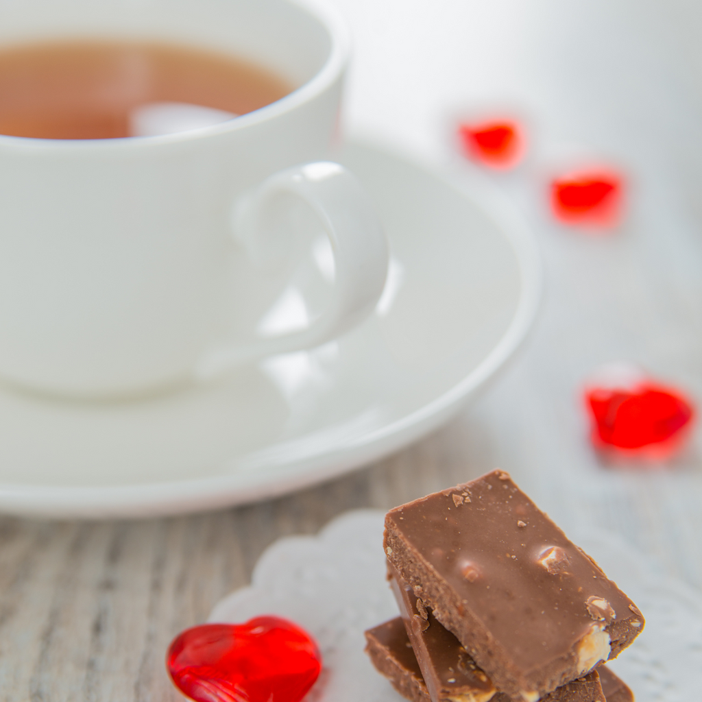 Milk chocolate with nuts is paired with a cup of black tea.